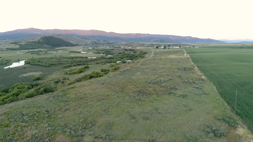 Expansive parcel featuring a blend of cultivated fields and natural terrain