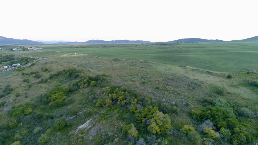 Expansive rural landscape featuring rolling hills and green fields