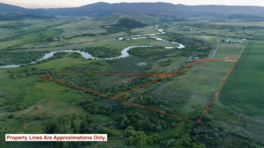 Expansive rural property featuring a winding river, mature trees, and varied terrain