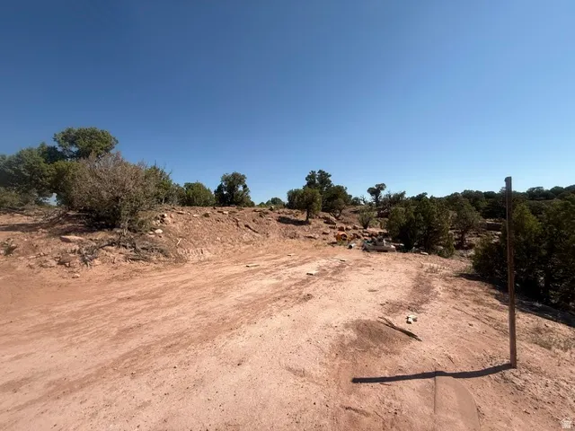Expansive undeveloped lot featuring natural desert landscaping and a clear, open sky