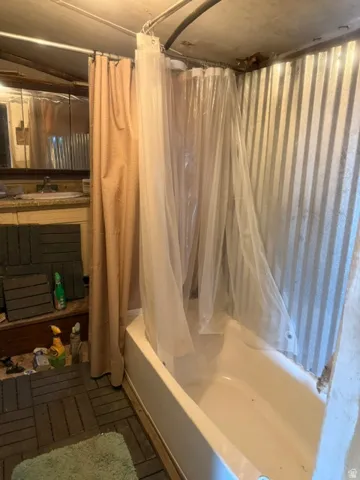 White bathtub with corrugated metal surround