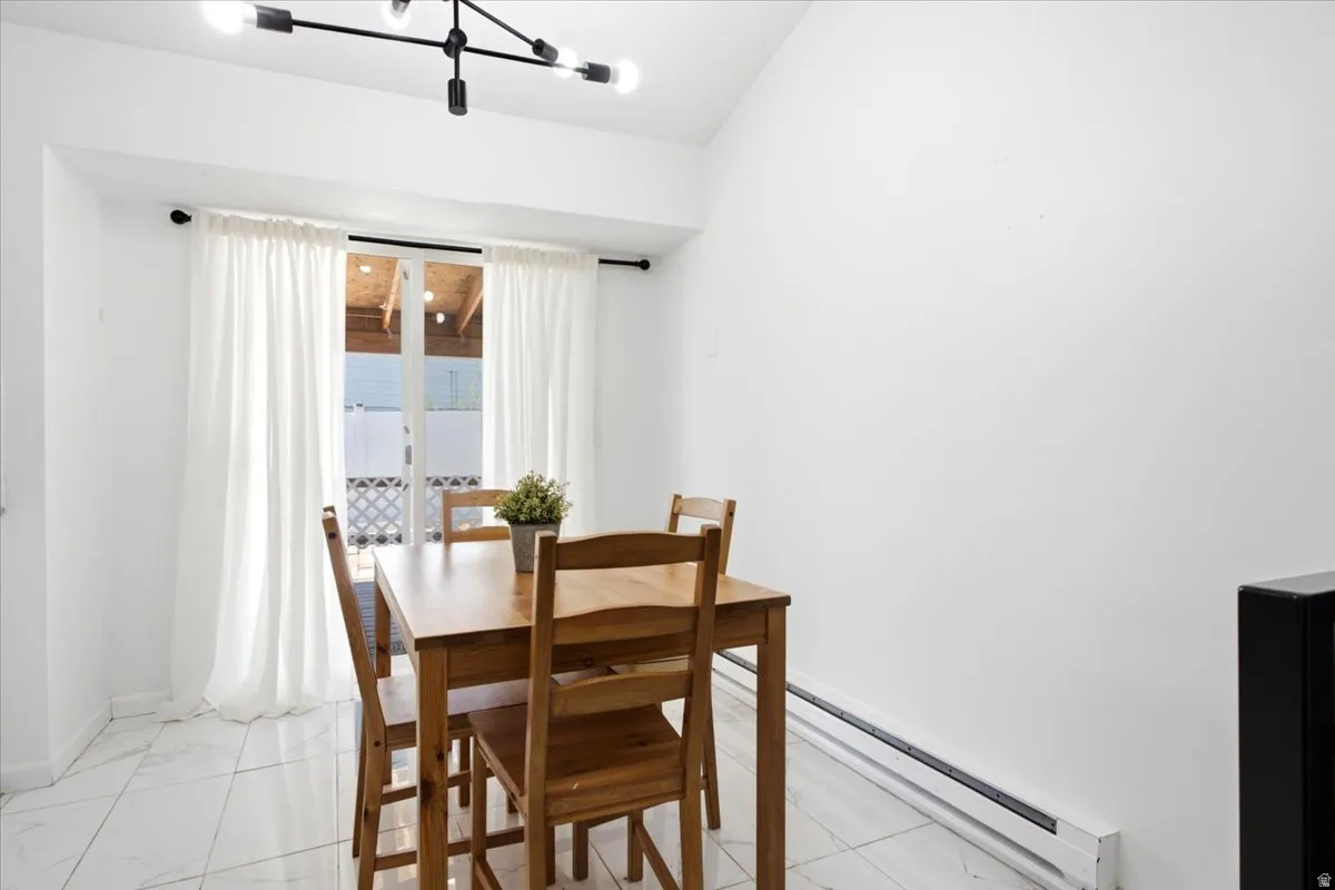 Bright interior room featuring white walls and white tile flooring
