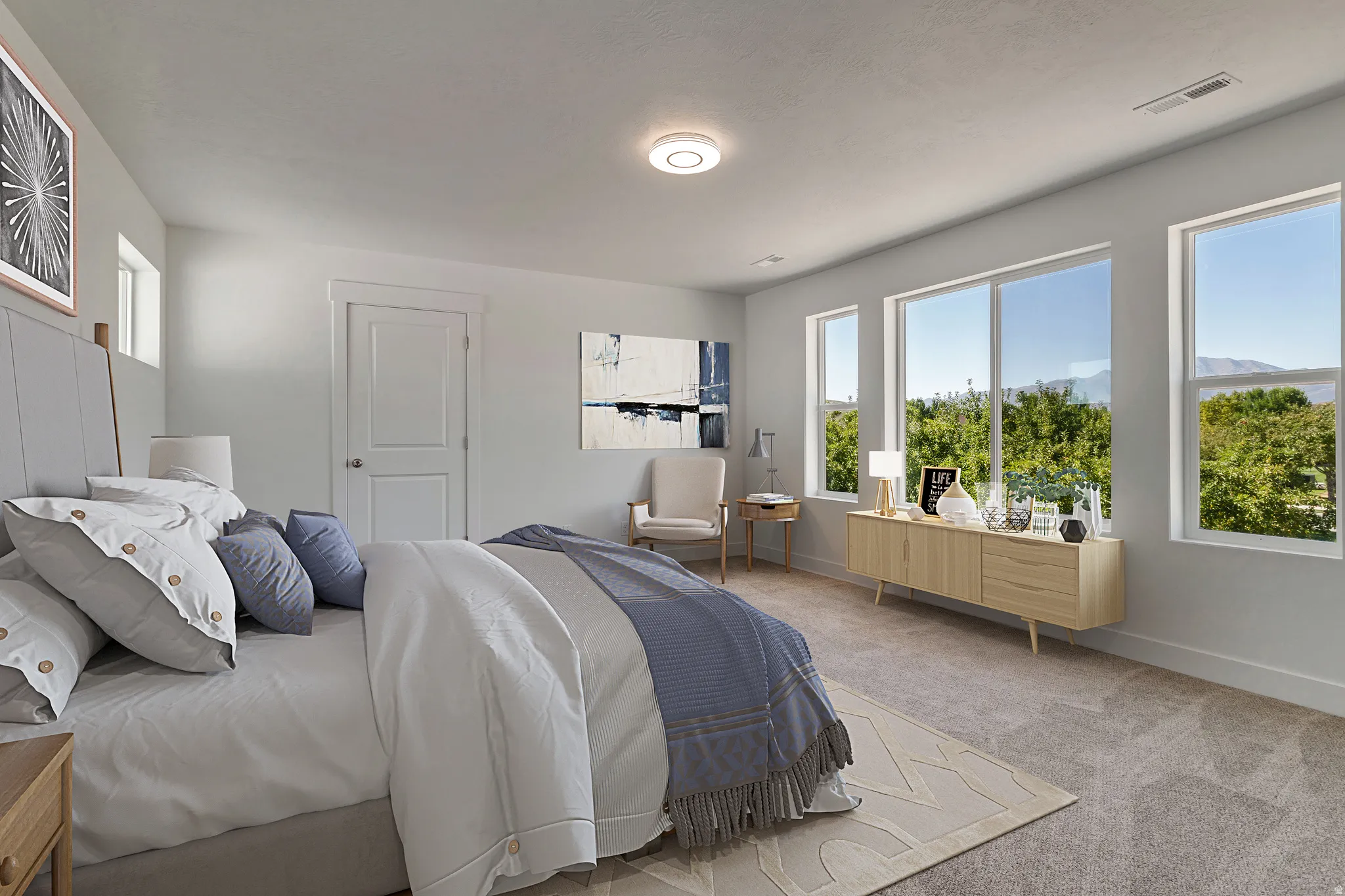 Spacious room with multiple large windows, light gray walls, and carpet flooring