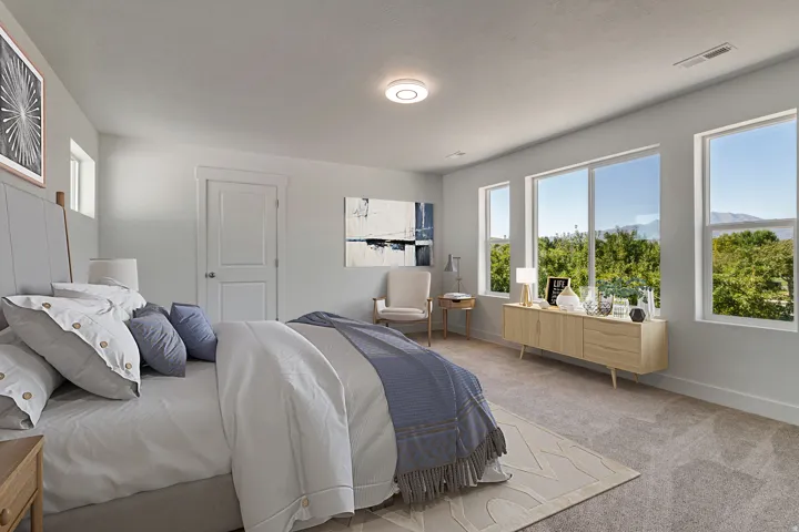 Spacious room with multiple large windows, light gray walls, and carpet flooring