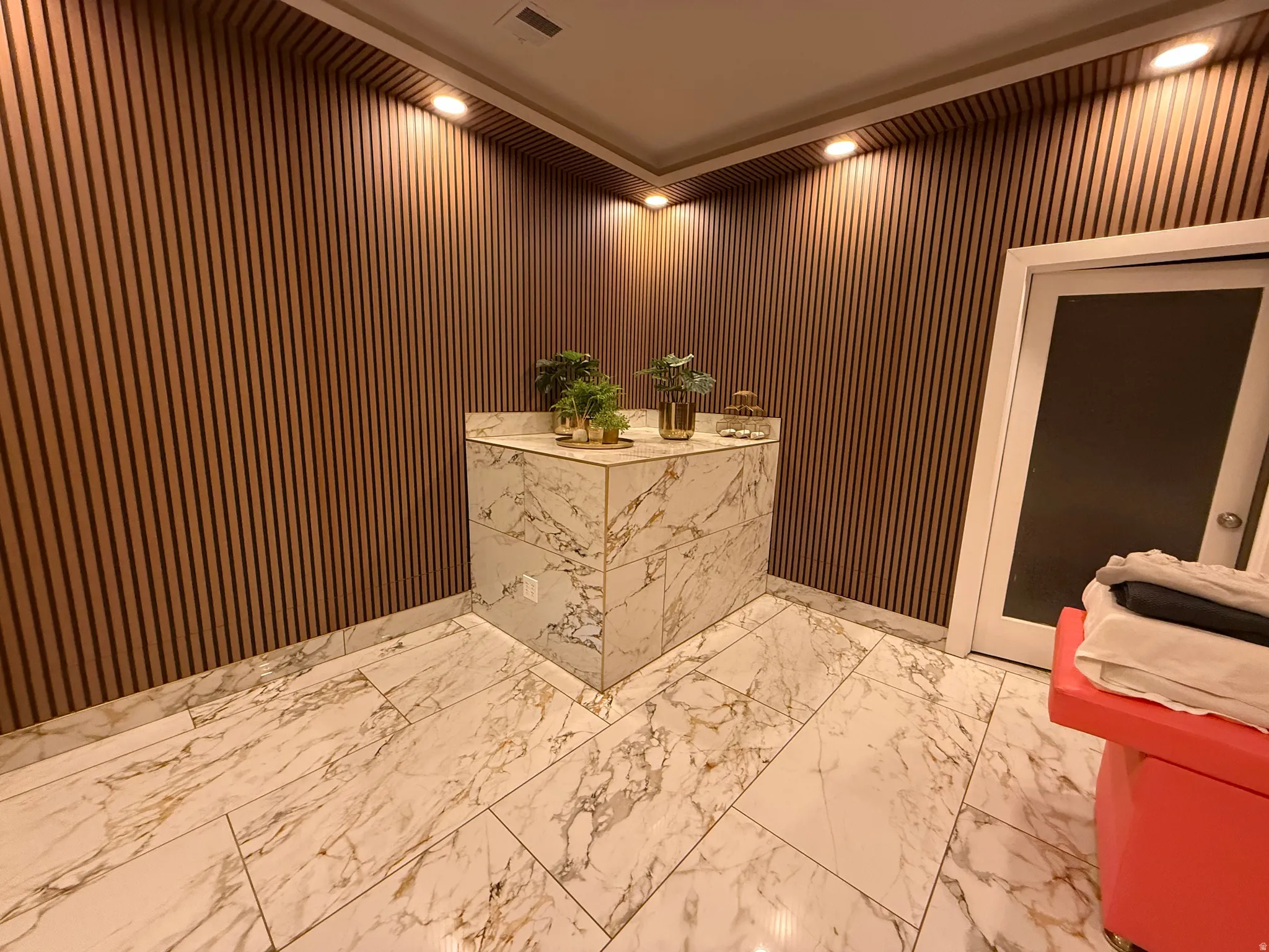 Accent wall with vertical wood slat paneling and recessed lighting