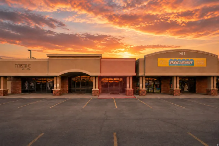 Commercial retail storefronts featuring large display windows and ample parking