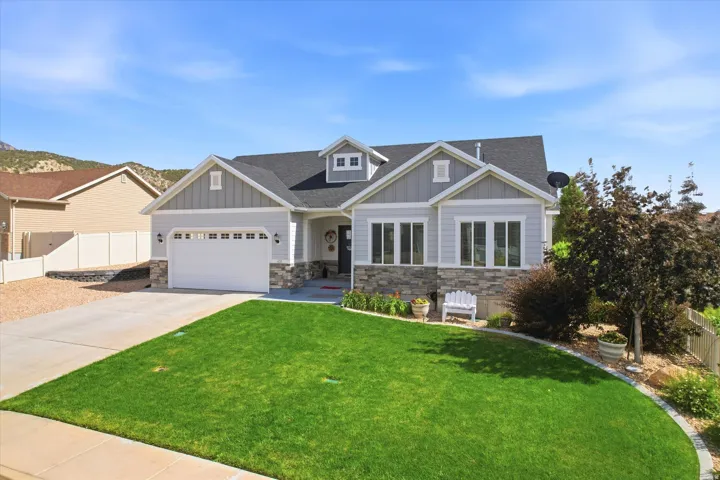 Modern ranch-style exterior with light gray siding and stone accents