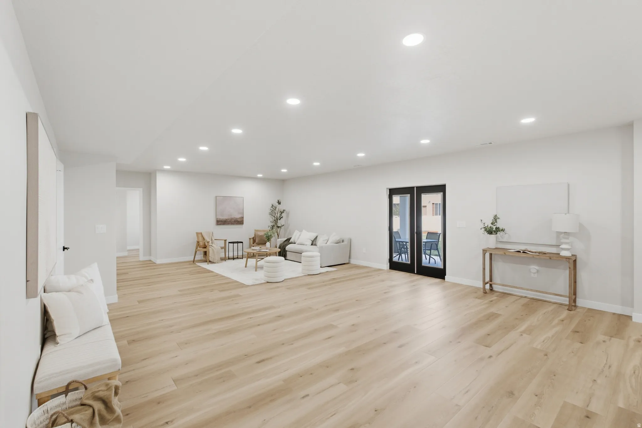 Open-concept space featuring light wood-finish flooring and recessed lighting throughout
