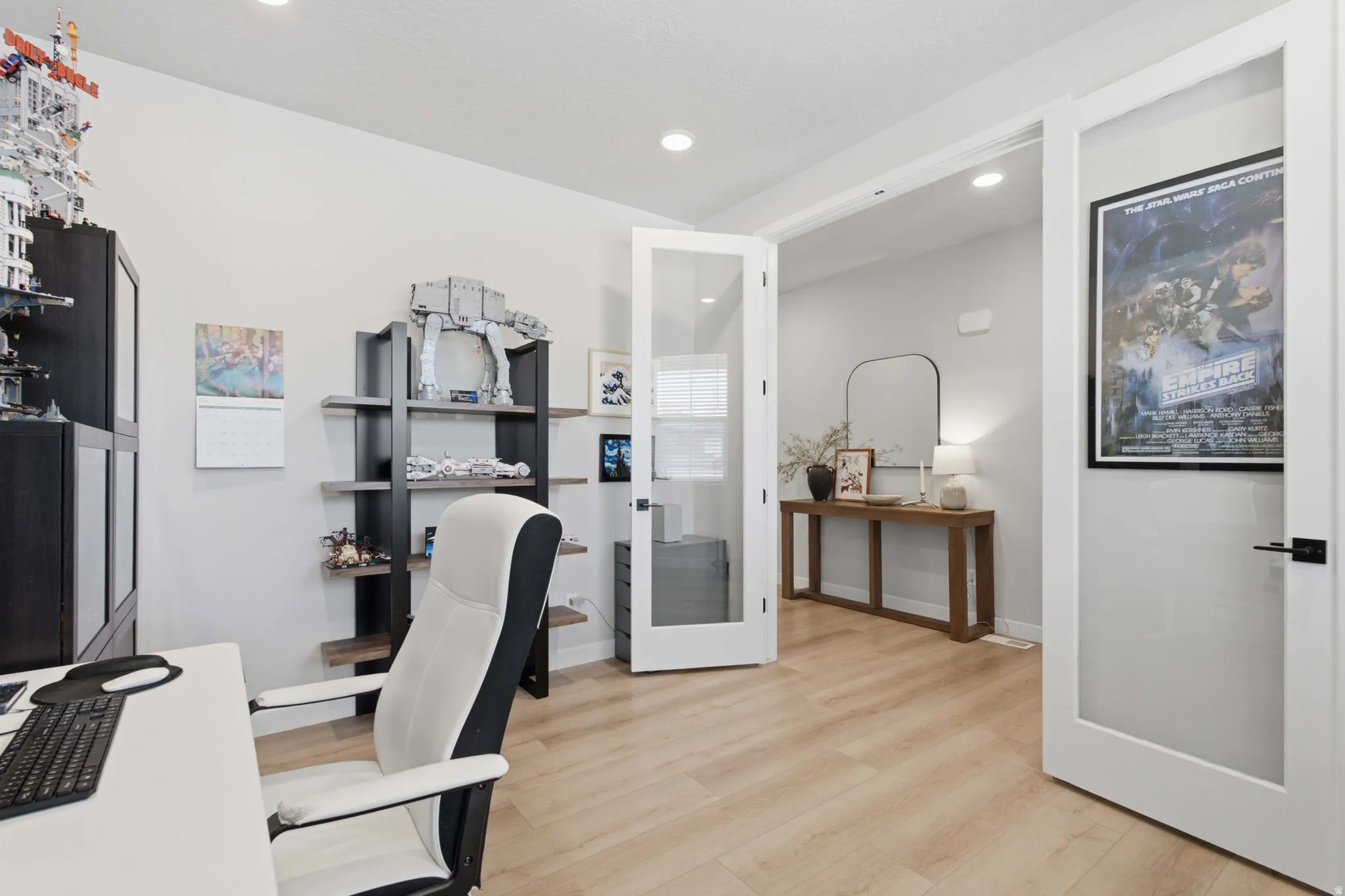 Light wood-finish flooring complements the neutral wall color