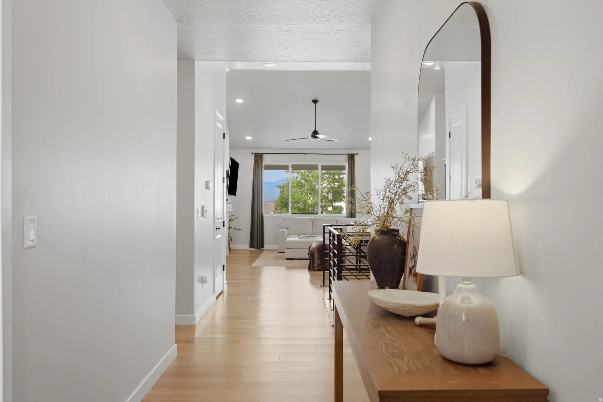 Light wood-finish flooring extending through an open-concept living area