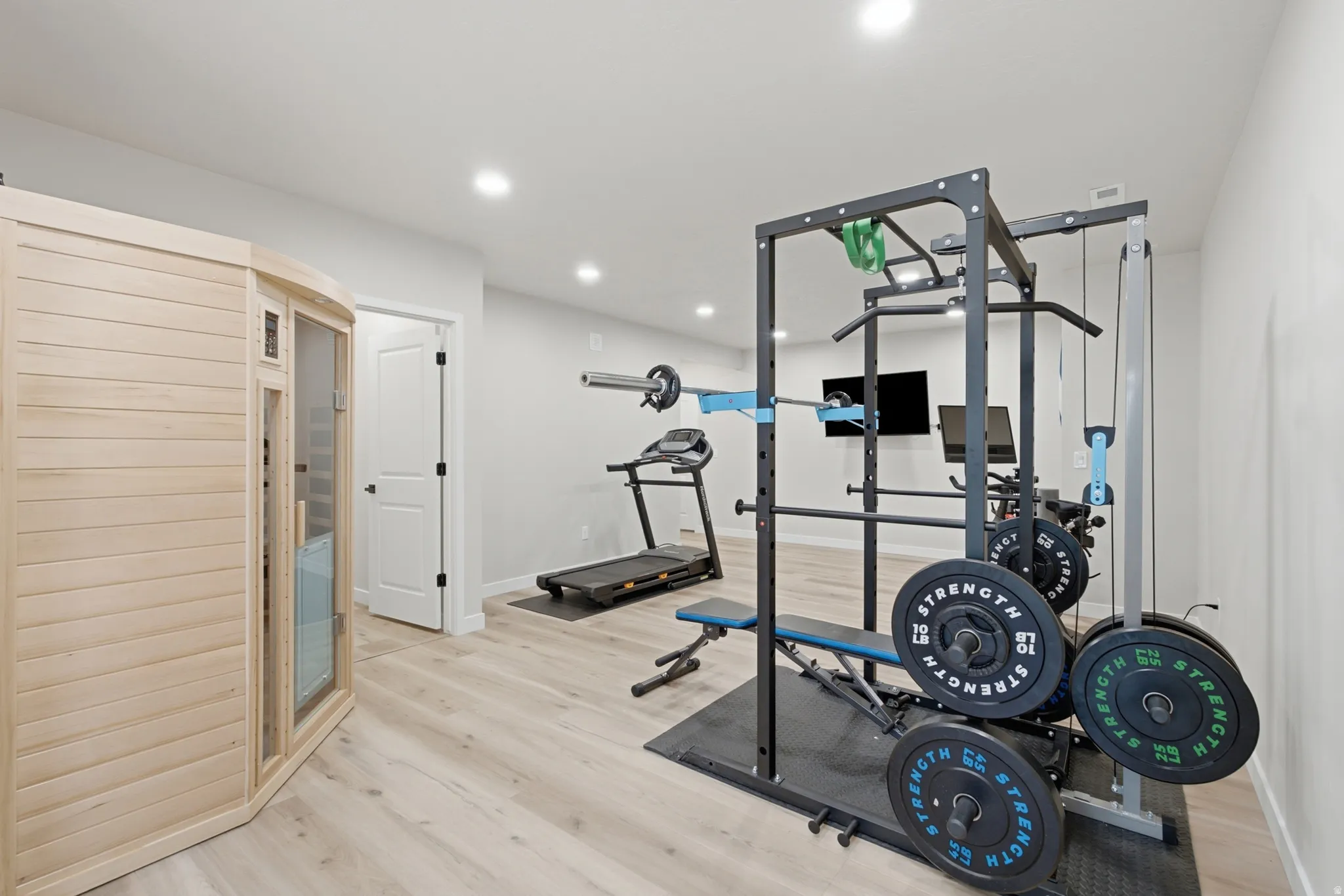 Large wellness room featuring indoor sauna