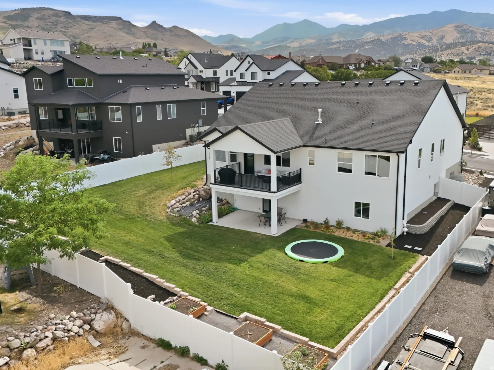 Contemporary white exterior with a dark shingle roof