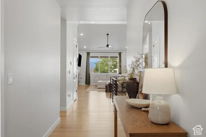Light wood-finish flooring extending through an open-concept living area