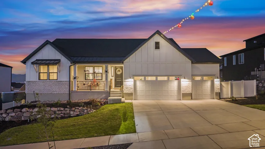 Modern farmhouse-style exterior with a dark roof and white siding