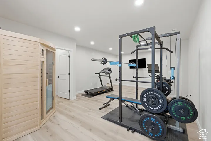Large wellness room featuring indoor sauna
