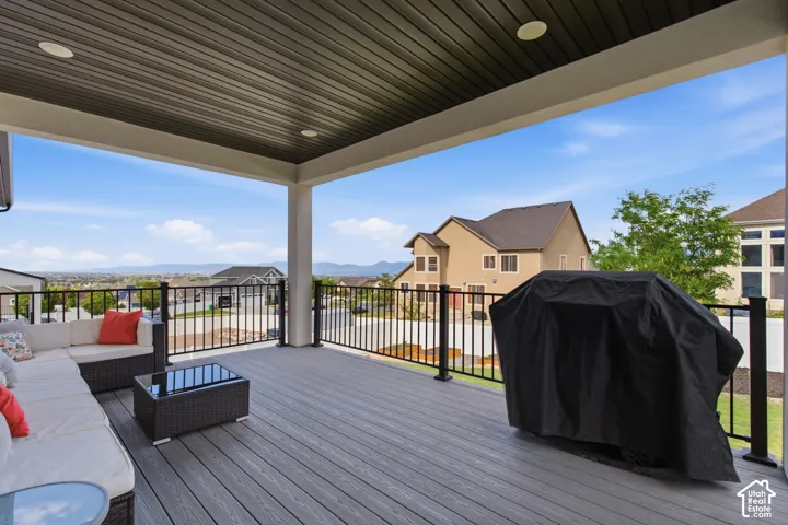 Large covered outdoor deck with wood-finish flooring