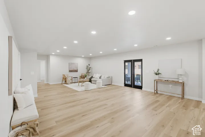 Open-concept space featuring light wood-finish flooring and recessed lighting throughout