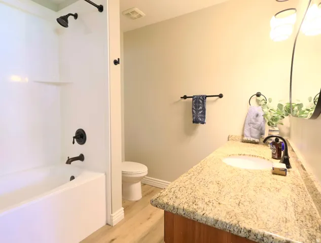 Bathroom featuring a full tub and shower combination with dark bronze fixtures