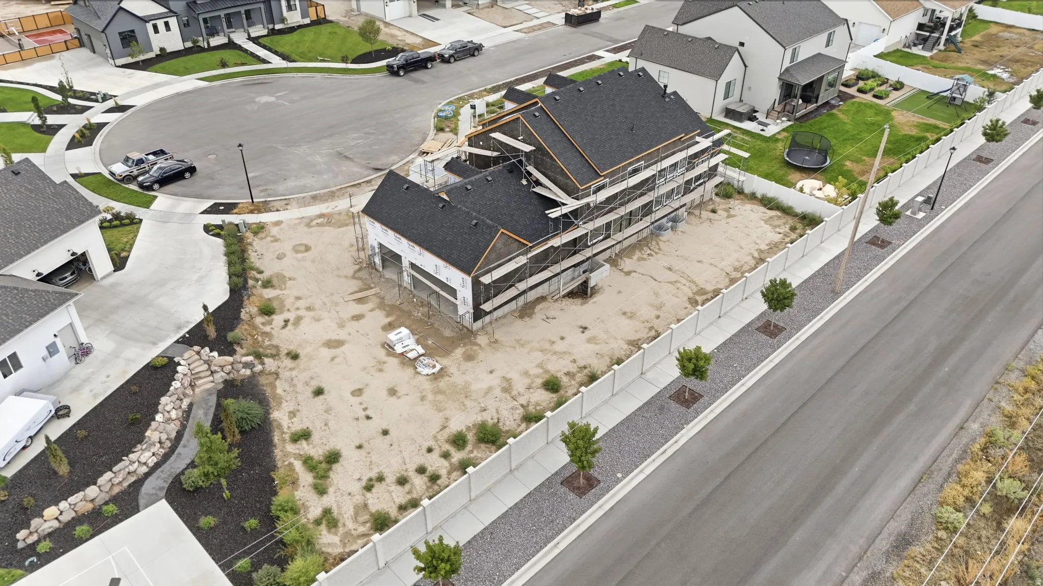 Two-story construction with a dark shingle roof and a two-car garage