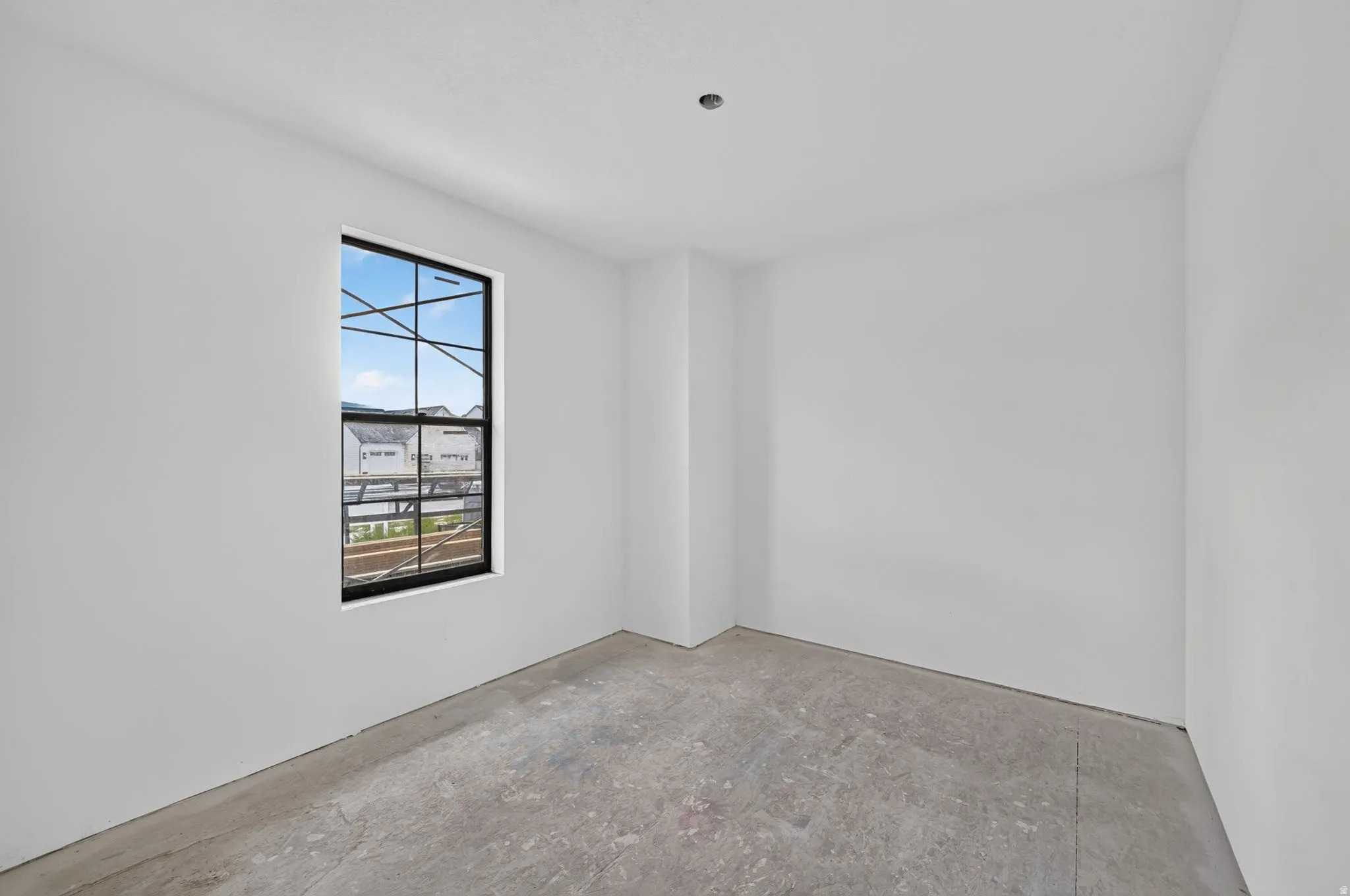 Black-framed window with multiple panes, providing natural illumination