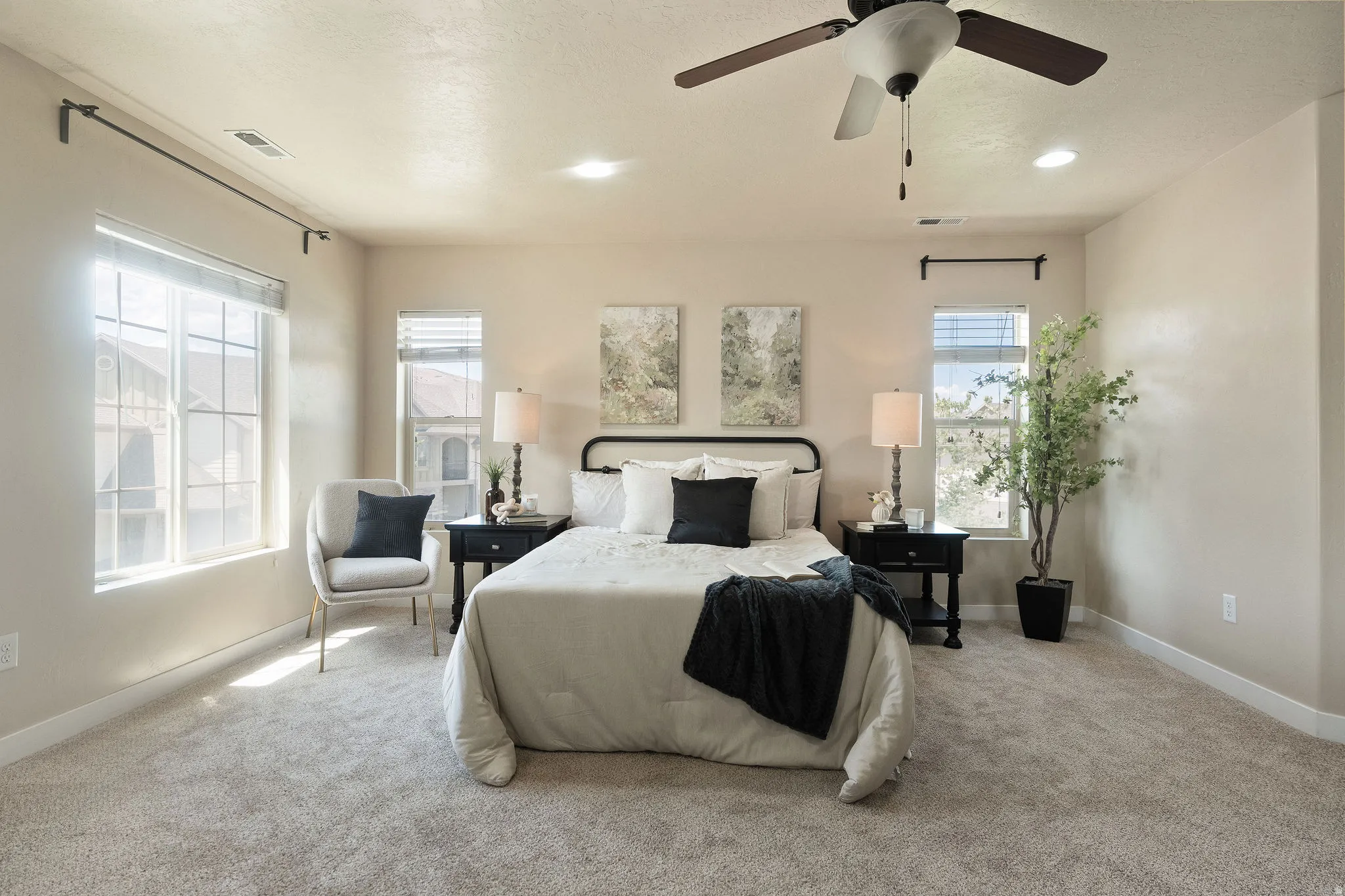 Bright bedroom featuring carpeted flooring, multiple windows with blinds, a ceiling fan, and recessed lighting