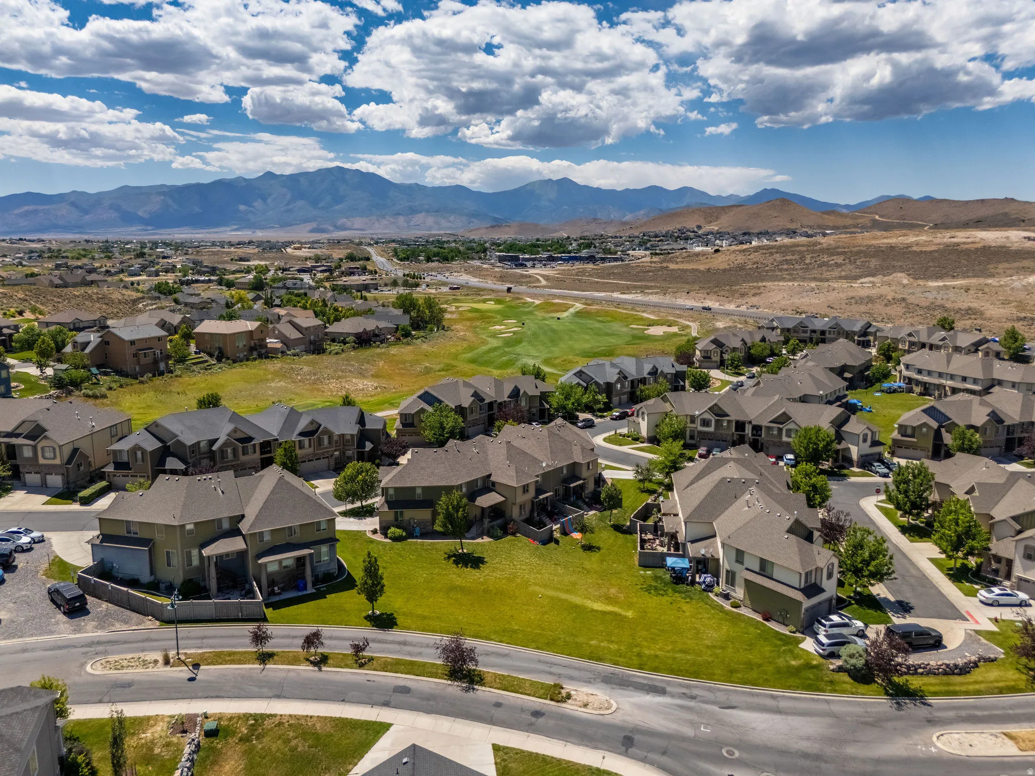 Expansive residential neighborhood featuring numerous two-story homes with pitched roofs and attached garages