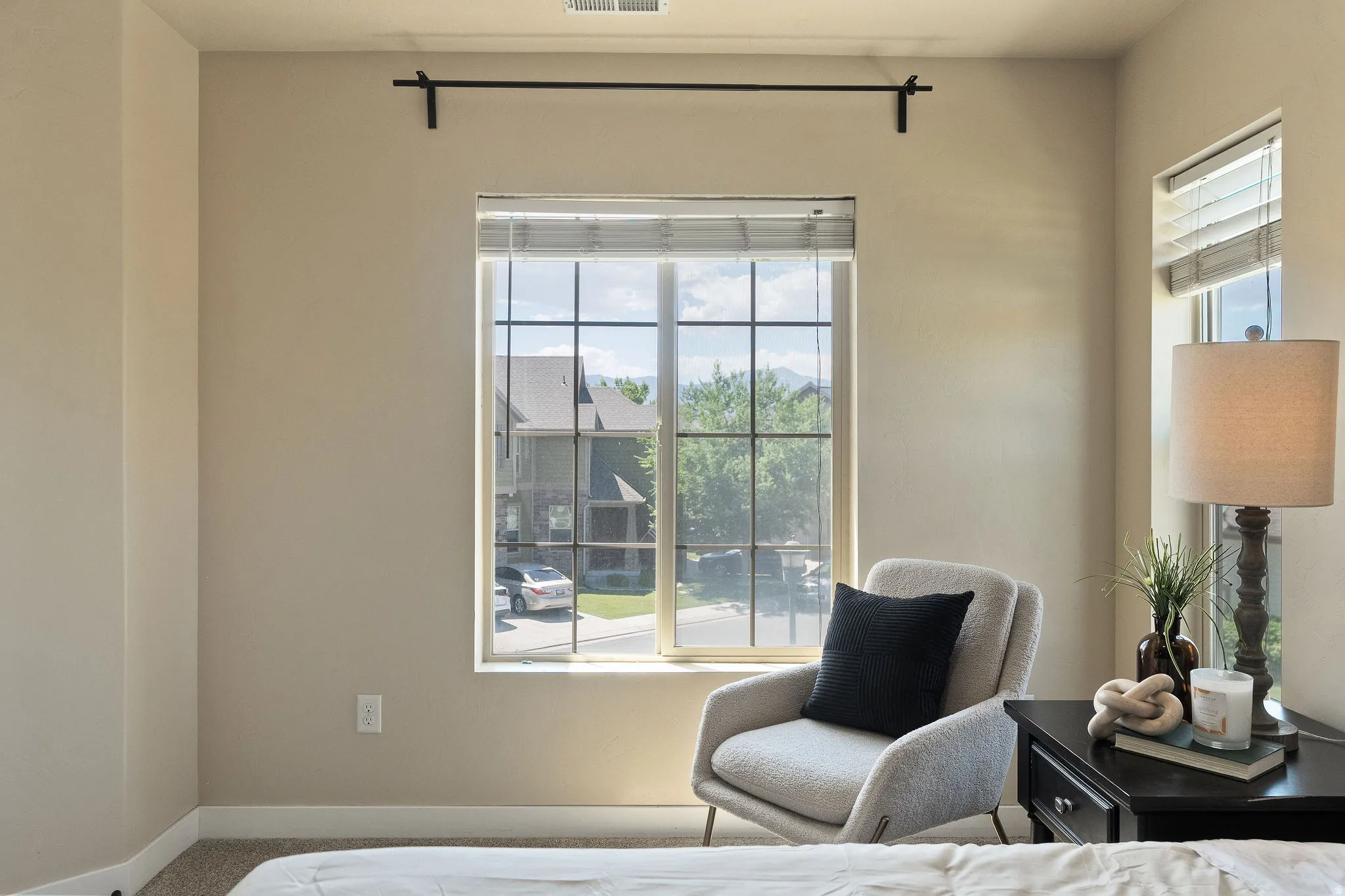 Large multi-pane window with blinds, framed by neutral painted walls
