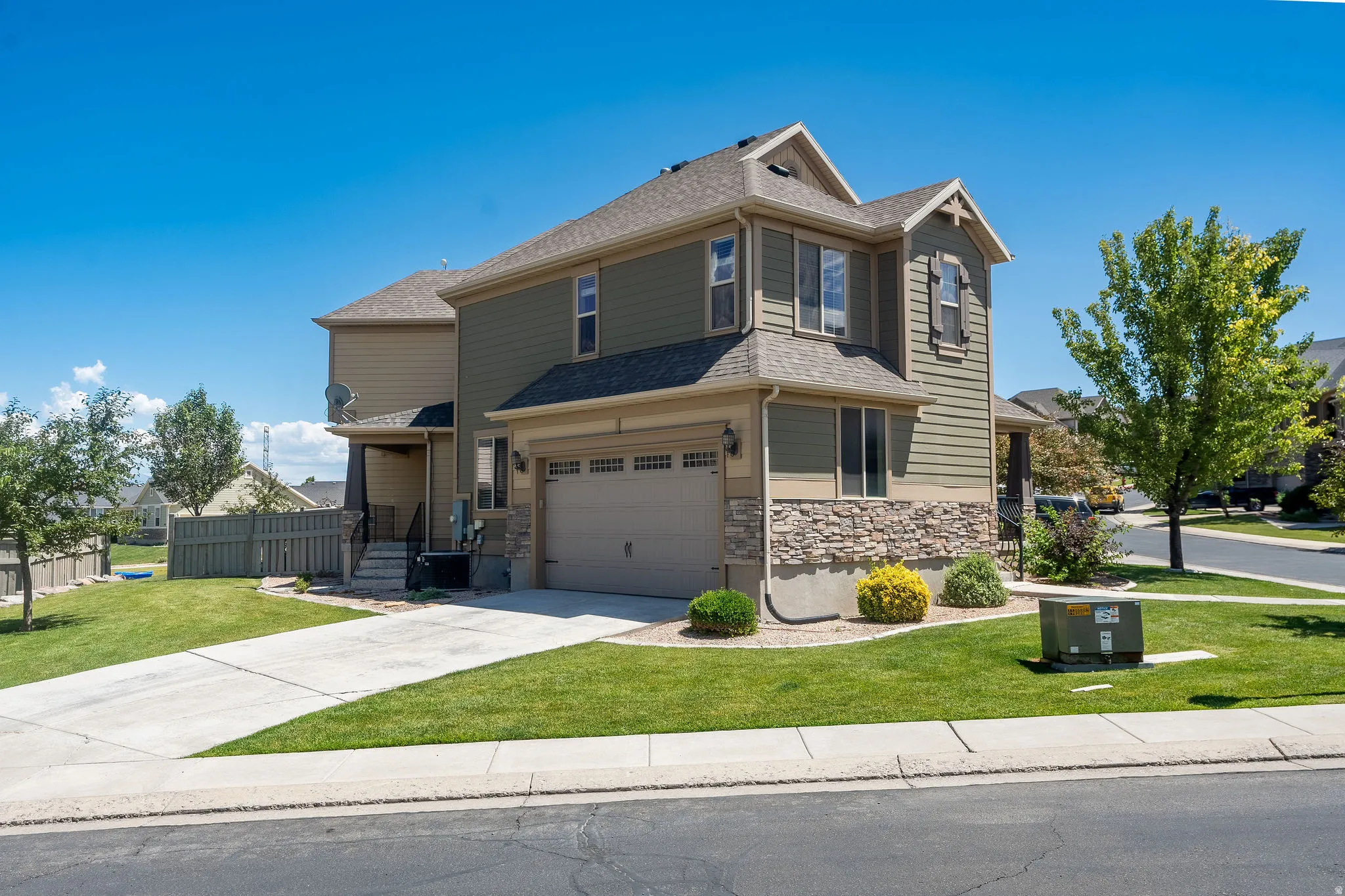Two-story residence featuring a two-car garage with an automatic door