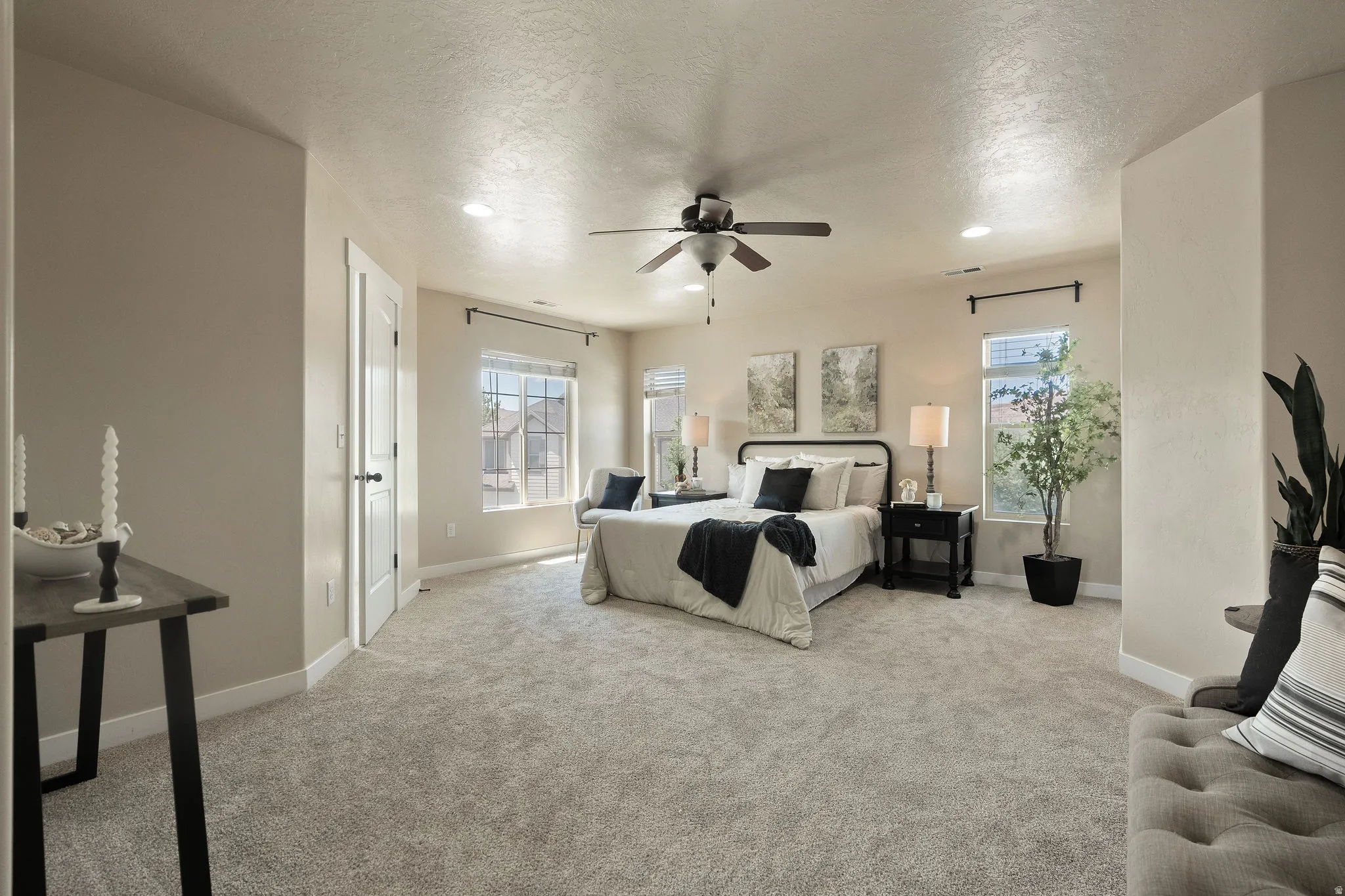 Spacious room featuring plush carpet flooring, recessed lighting, and a ceiling fan