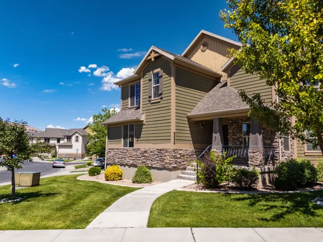 Two-story residence featuring horizontal siding and stone veneer accents