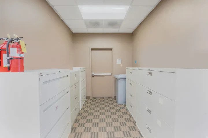 Hallway featuring neutral wall paint and a patterned floor