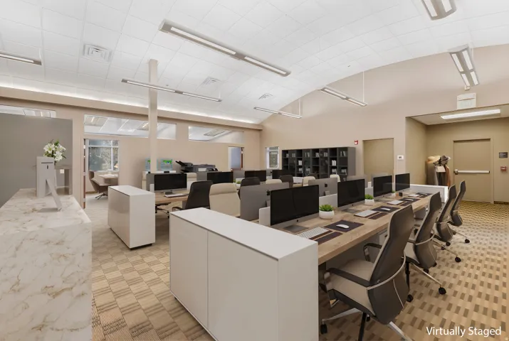 Spacious open-plan office area featuring an arched ceiling, recessed linear lighting, and large windows, staged with wood-finish workstations