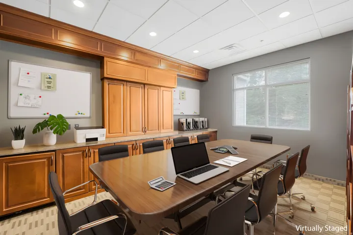 Conference Room with Built-in wood cabinetry with a light-toned countertop, a large window, recessed lighting, and patterned carpet