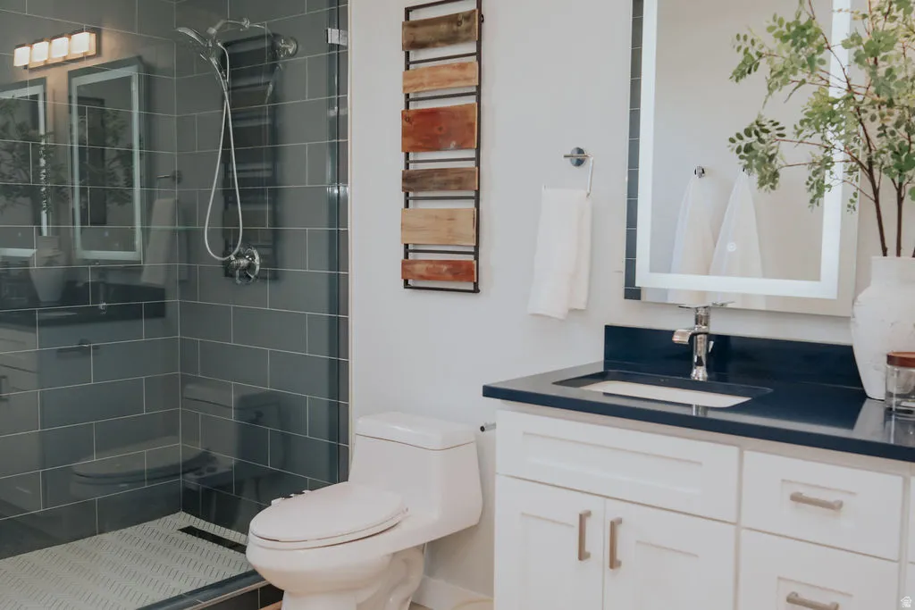 Modern bathroom featuring a glass-enclosed shower with subway tile surround and a tiled floor