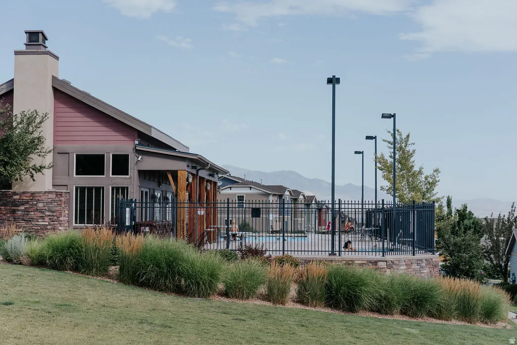 Clubhouse exterior featuring a neutral-toned chimney and red siding