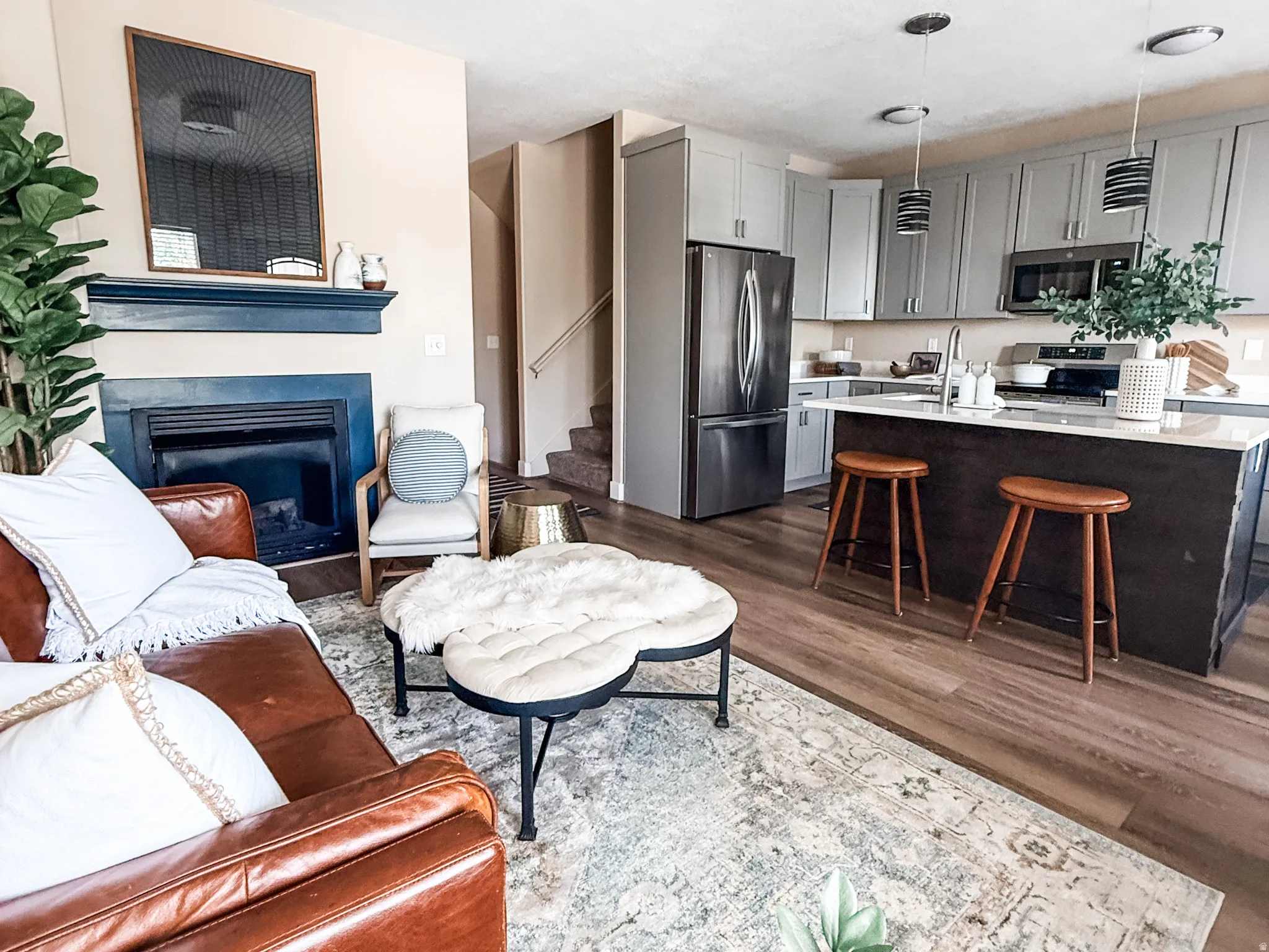 Combined living and kitchen space featuring wood-finish flooring