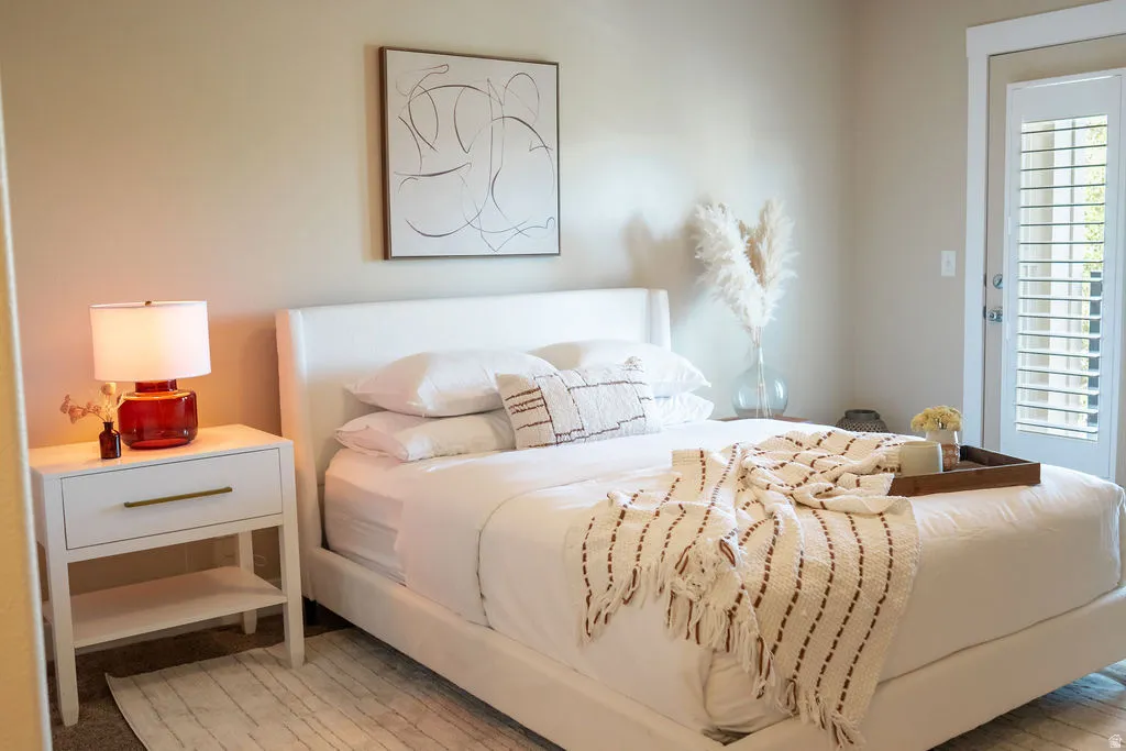 Neutral wall tones with a built-in white wood nightstand featuring a brass pull