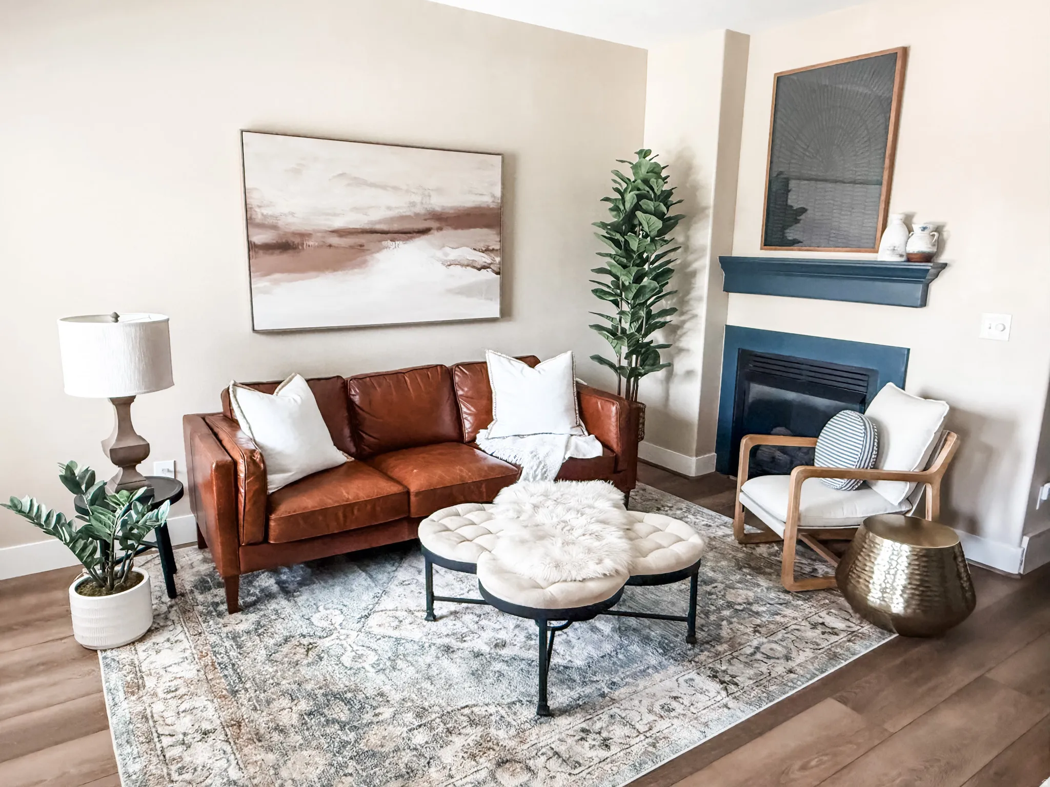 Living area featuring wood-finish flooring and a built-in fireplace with a blue surround and mantle