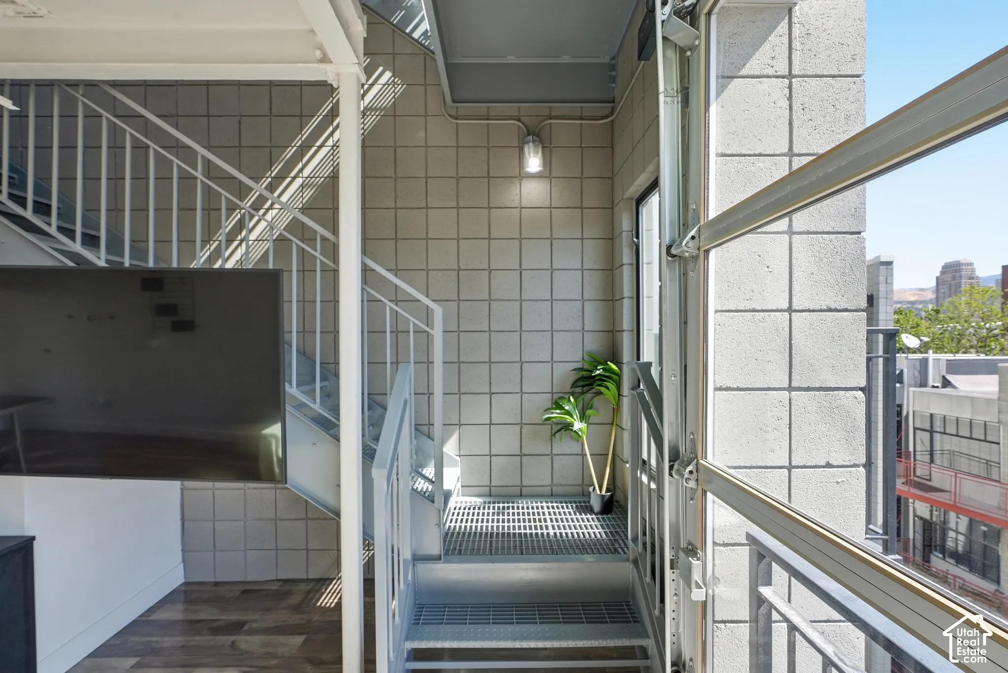 Industrial-style staircase with metal railings and perforated treads