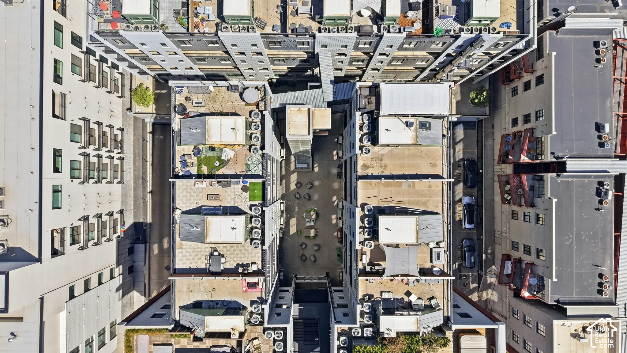Modern urban residential complex featuring multiple buildings and diverse rooftop spaces