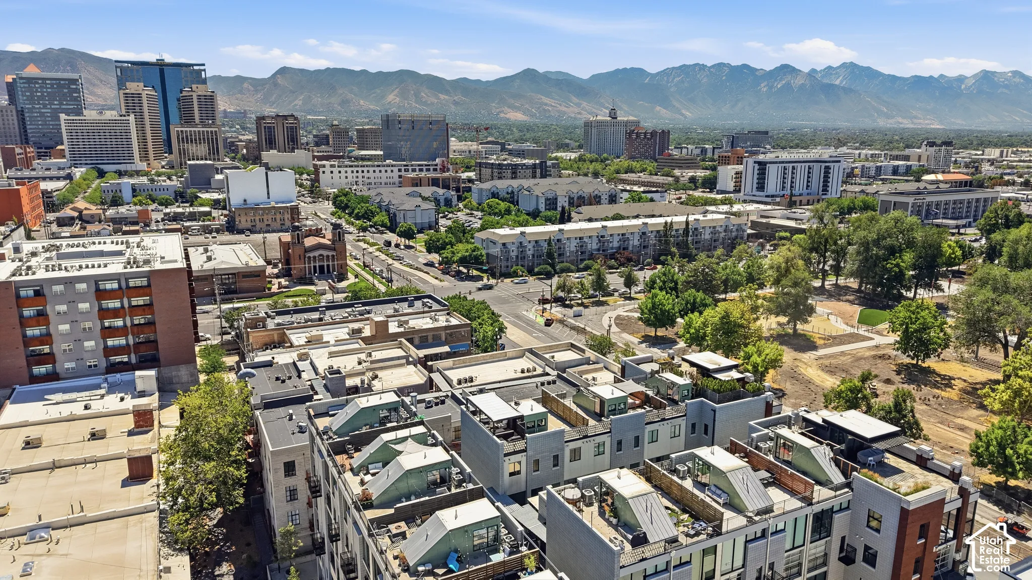 Rooftop patio with cityscape and mountain backdrop