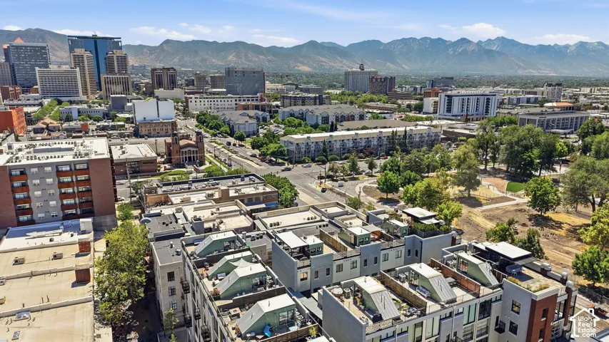 Rooftop patio with cityscape and mountain backdrop