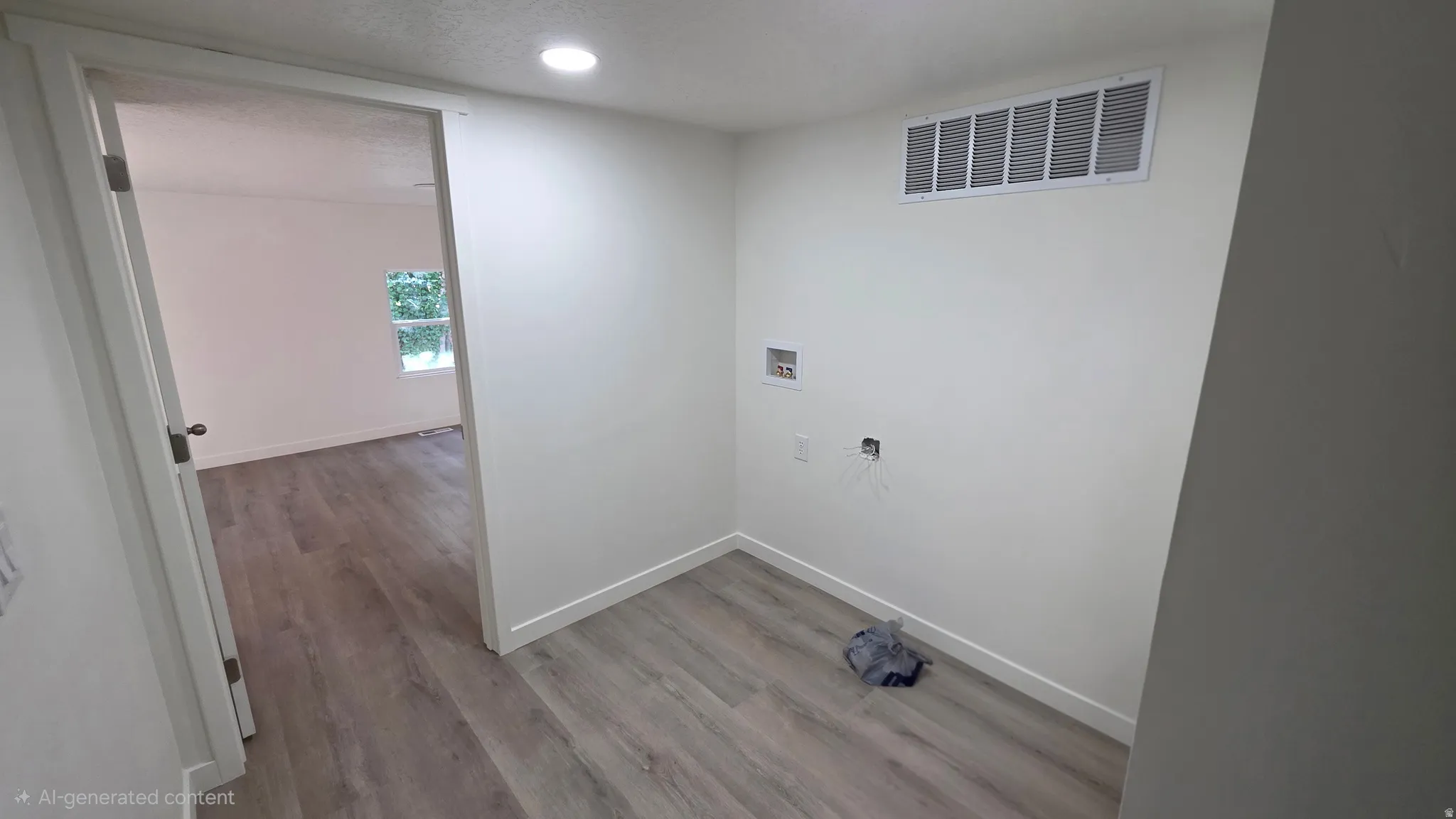 Dedicated utility space with contemporary wood-finish flooring, recessed lighting, crisp white walls, and baseboards