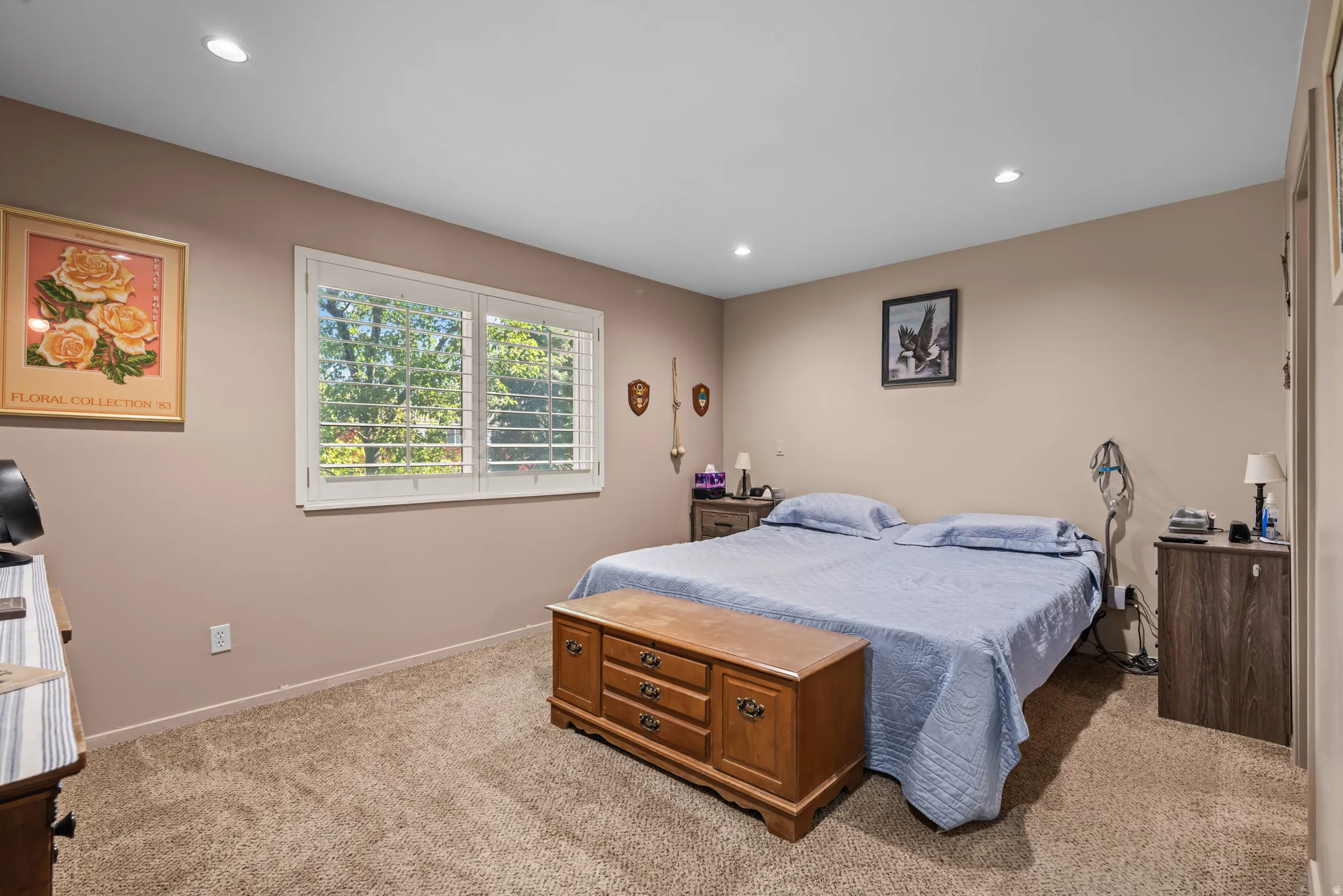 Carpeted room featuring a double window with white plantation shutters, recessed lighting, and neutral-toned walls