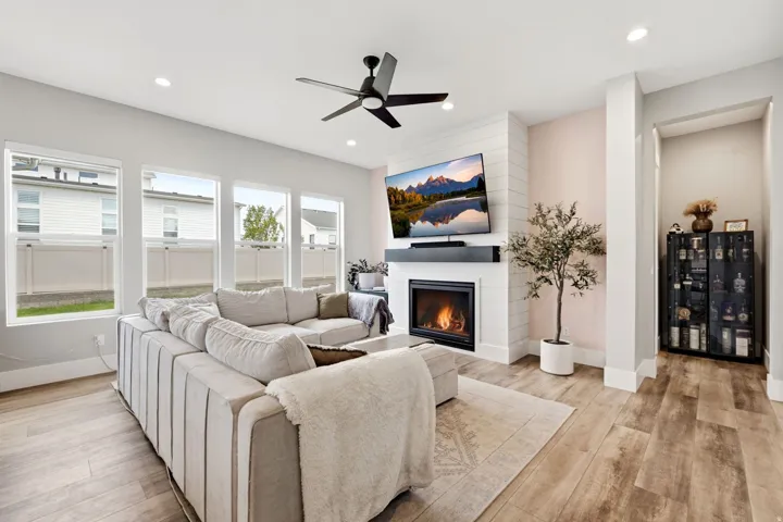 Spacious living area featuring plank wood-finish flooring and recessed lighting