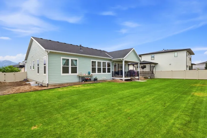 Expansive green lawn with a vinyl privacy fence