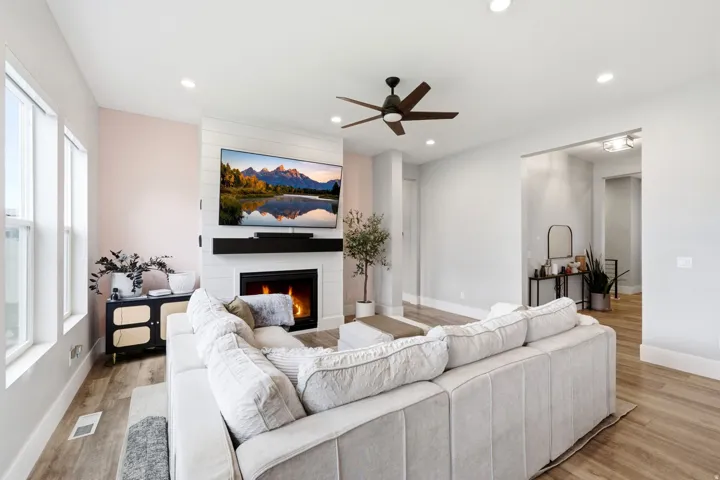 Living area featuring wood-finish flooring and recessed lighting