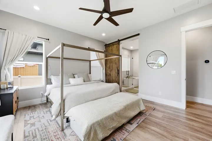 Spacious room featuring wood-finish flooring and a ceiling fan
