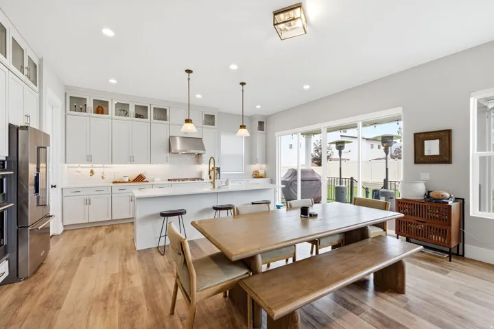 Open-concept kitchen and dining area featuring light wood-finish flooring