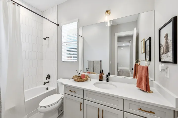 Bathroom featuring a white subway tile surround tub and shower with matte black fixtures
